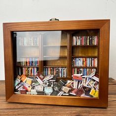 a wooden book case filled with lots of books