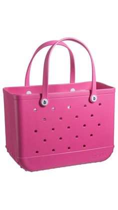 a pink tote bag with eyeballs on the front and side handles, sitting against a white background