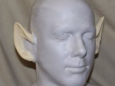 a white male mannequin head with horns on it