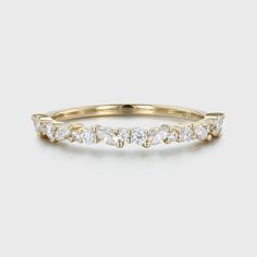 a yellow gold band with white diamonds