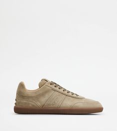 Tod's sneakers in fine suede with slight vintage effect, side stamped Tod's logo, rubber pebble detailing on the heel and rubber outsole. Suede Sneakers With Embossed Logo And Round Toe, Suede Sneakers With Embossed Logo, Classic Suede Sneakers With Stitched Sole, Classic Suede Sneakers With Leather Sole, Classic Sneakers With Suede Lining And Round Toe, Italian Mens Fashion, Beige Sneakers, Brown Sneakers, Gigi Hadid