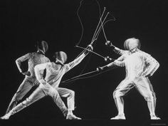 an old photo of two men playing with a bow and arrow