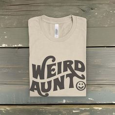 Own your status as the coolest weird aunt on the bloc or get one as a gift for your chaotic sister. Either way you'll love this soft aunt shirt. More colors may be available, just send me a message and ask! Classic fit soft jersey knit; order at least a size up for an oversized fit 👕  🌎 MADE TO ORDER IN THE USA, NEVER MASS PRODUCED 🌍 If this is up your alley then be sure to go check out my shop for more goodies: chaoticgoodthings.etsy.com - CHOOSING A SIZE - If you have doubts about the right choice here's the secret to choosing the perfect size: (1) Grab your favorite regular fit t-shirt from your closet and lay it out on your bed. (2) Measure the distance from arm pit to arm pit - this is your Width. (3) Repeat this process for the Length of the garment by measuring from top to bottom Funny Graphic Print Tops As Gift, Retro Tops With Funny Print As Gift, Fun Tops With Funny Text For Gifts, Funny Text Print Tops As Gift, Novelty Letter Print Tops As Gift, Novelty Tops With Funny Text As Gift, Novelty Tops With Funny Text For Gifts, Funny Slogan Tops As Gifts, Funny Slogan Tops For Gifts