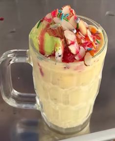 a glass cup filled with fruit and ice cream