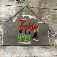 a sign that says,'tinkle all the way'hanging on a wall