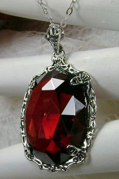 "Red Garnet Cubic Zirconia Pendant Bubble Design#P10 Custom Made Inspired by Victorian era designs, I now offer this lovely Antique reproduction in sterling silver. The flawless 22ct faceted Red Garnet Cubic Zirconia (CZ) is 24mm long (15/16th\") and 18mm in width (3/4th\"). The entire pendant is 1 1/2th inches long and 7/8\" wide. The chain (if chosen) is between 18-20 inches in length and is marked 925 as well. Notice the beautiful craftsmanship of the Victorian filigree setting. This pendant Exquisite Red Jewelry For Gift, Red Crystal Pendant Jewelry, Red Jeweled Jewelry For Anniversary, Red Victorian Necklace For Anniversary, Red Gothic Necklace For Formal Occasions, Red Oval Victorian Jewelry, Red Jeweled Jewelry For Evening, Red Necklace With Intricate Design For Party, Party Red Necklace With Intricate Design