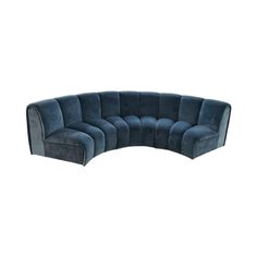 the curved sectional sofa is made from dark blue velvet and has an extended back end