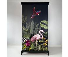 an armoire with a painting of a flamingo and other tropical plants on it