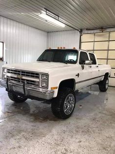 a white pickup truck parked in a garage