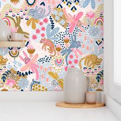 the wallpaper in this kitchen is very colorful