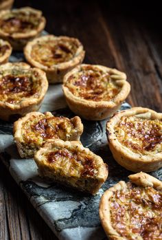 several mini quiche pies sitting on top of a table