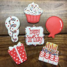 decorated birthday cookies on a wooden table