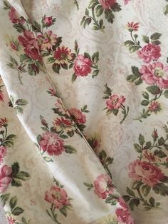 the fabric has pink flowers on it