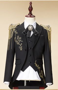 This luxury 6-piece suit is perfect for special occasions and festive moments. Our Royal Black & Gold suit comes with the signature jacket, vest, white shirt, pants, and stylish brooch. All 4 pieces are tailored in modern styling. Your little one will feel like royalty in this elegant suit. Get this tuxedo today! Sizing Chart Product Details: Fit: Fits true to size, take your normal size Style: Formal Closure Type: Single Breasted Pattern Type: Solid Collar: Notched Trouser Closure Type: Elastic Royal Tuxedo For Men, Black Prince Suit, Fancy Tuxedo For Men, Royal Ball Men Outfit, Men Royal Outfit, Prince Wedding Suit, Mens Couture Fashion, Black And Gold Formal Outfit Men, Royal Men Outfit