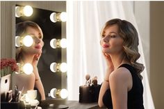 a woman looking at herself in the mirror