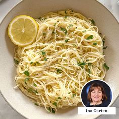 a white bowl filled with pasta and lemon wedges next to a photo of ina gartern