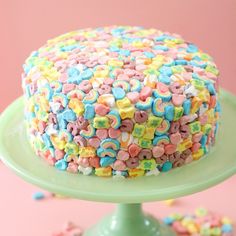 a colorful cake with sprinkles on a green plate