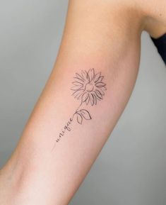 a woman's arm with a flower tattoo on it