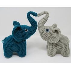 two crocheted elephants are standing next to each other, one is blue and the other is gray