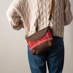 Red Fabric and Brown Leather Adjustable Crossbody Purse Wear as crossbody or remove strap and use as a clutch bag. ONE OF A KIND Leather is natural and unique, adding character & making each product imperfectly beautiful. Each piece is a handcrafted one-of-a-kind piece. The bag you receive will differ from the photograph, but we will ensure that yours is just as beautiful. SIZE Crossbody 8 high x 9 1/2 wide x 2 " Deep Strap  3/4" wide Detachable & Adjustable  MATERIALS Genuine Kodiak Leather Ant Red Leather Handle Pouch Shoulder Bag, Crossbody Clutch As A Gift, Red Mobile Phone Pouch For Everyday Use, Red Bags With Zipper Pouch For Everyday Use, Gift Crossbody Pouch, Red Everyday Pouch, Crossbody Pouch With Adjustable Strap, Red Pouch With Removable Feature For Everyday Use, Crossbody Pouch With Adjustable Strap For Gift