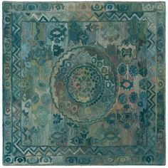 an area rug with many different colors and designs on the carpet, including blue, green,