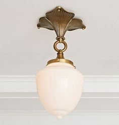 the light fixture is hanging from the ceiling in the room with white walls and trimmings