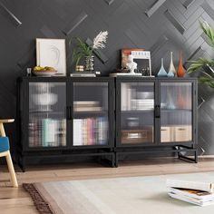 a living room with a rug, chair and bookcase on the floor in front of a gray wall