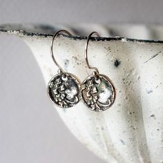 These dainty Victorian button earrings are so tiny and cute!  I cast them in sterling silver precious metal clay from an original Victorian era button and then oxidized them to bring out the beautifully detailed design, which is a trumpet flower with a lattice ornament. ✩ Tiny flowers are sterling silver recycled from industrial processes ✩ Sterling silver French earwires ✩ Oxidized with an antique finish to bring out the textural detail ✩ 3/4 inches (about 19mm) long Please visit my home page t Delicate Nickel-free Silver Earrings, Dainty Small Silver Earrings, Silver Stamped Earrings For Everyday, Delicate Silver Round Earrings, Elegant Stamped Earrings As Gift, Everyday Silver Stamped Earrings, Delicate Sterling Silver Flower Earrings, Silver Dainty Flower Earrings For Everyday, Dainty Silver Flower Earrings For Everyday