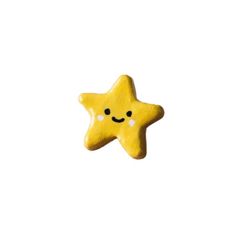 a yellow star shaped cookie with a smiley face on it's side, against a white background