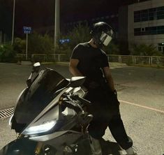 a man sitting on top of a parked motorcycle