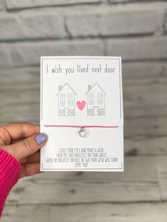 someone is holding up a card that says i wish you lived next door with a heart on it