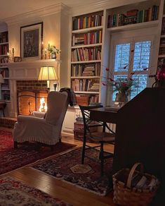 a living room filled with furniture and a fire place next to a book shelf full of books