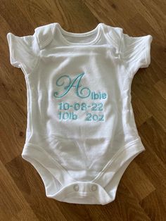 White 0-3 months short sleeved  baby  grow embroidered with name, date and weight of the new arrival can be made in a selection of different colours.  Perfect gift idea for a new arrival  All handmade to order usually takes 2/3 days to create White Personalized Short Sleeve Onesie, White Short Sleeve Onesie For First Birthday, Cotton Baptism Onesie With Short Sleeves, White Short Sleeve Onesie For Baptism, White Short Sleeve Bodysuit As A Gift, White Short Sleeve Bodysuit As Gift, Personalized Short Sleeve Onesie For Gift, Personalized Short Sleeve Onesie As Gift, Short Sleeve Bodysuit With Name Print For Gifts