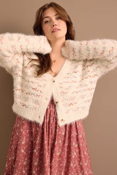 This cardigan is a cozy yet stylish addition to your wardrobe, featuring a soft, textured knit with a delicate design. Featuring three front buttons, making it perfect for layering over your favorite outfits while keeping you warm and chic. Feminine Soft Knit Sweater For Winter, Feminine Soft Knit Winter Sweater, Feminine Winter Sweater For Layering, Feminine Cream Cardigan For Winter, Feminine Fall Sweater For Layering, Feminine Layering Sweater For Fall, Feminine Winter Layering Sweater, Feminine Button-up Fall Outerwear, Feminine Button-up Outerwear For Fall