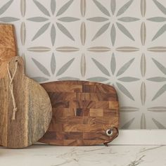 a wooden cutting board sitting on top of a counter next to a cutting board and knife