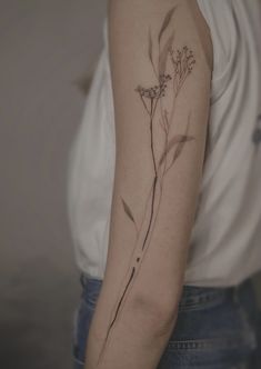 a woman with a flower tattoo on her arm