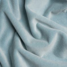 a close up view of a light blue fabric