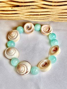 Beautiful summer "beach vibe" soft blue quartz bead and real seashell bracelet. Stretch band for comfort and easy on and off. Such a fun and pretty piece to show off for the summer! One of my favorites. Shells are smooth and sit comfortably on your wrist. 6.5 inch fits 6-7 inch wrist comfortably. 10mm beads. Shells average 16mm. Handmade Beachy Stretch Bracelet For Vacation, Beachy Handmade Stretch Bracelet For Vacation, Casual Beach Beaded Bracelets With Natural Stones, Casual Beaded Bracelets With Natural Stones For Beach, Light Blue Beaded Bracelets For Summer Gift, Light Blue Beaded Bracelets As Summer Gift, Summer Light Blue Beaded Bracelets As Gift, Turquoise Bohemian Stretch Bracelet For Summer, Bohemian Turquoise Stretch Bracelet For Summer