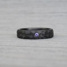 If you are looking for something special and unique for your wedding ring a carbon fiber ring with purple CZ diamond is the right choice for you. Carbon is the latest trend in jewelry making because it is ultralight and offer elegant carbon black look. With black carbon fiber ring you will stand out from the crowd and surely attract attention. All carbon fiber rings are hypoallergenic. Special obsidian shape ring for men. This ring is made from 50K carbon fibers, same as used in aviation industry. Carbon fiber rings are extremely light, with a minimalist industrial look. Ring is packed in a heart-shaped gift box. WHAT IS MY SIZE? For the right ring size it is best to go your local jeweler. Each ring is made to order and I do not keep stock. However, I stick to the written production time. Carbon Wedding Ring, Goth Wedding Ring, Wedding Ring Redesign, Fiber Rings, Ring Redesign, Carbon Fiber Ring, Carbon Fiber Rings, Obsidian Ring, Ring Purple