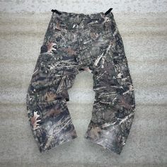 "Vintage Hunting Camo Tactical Pants Baggy Fit Cargos Crazy Woodland Pattern Bear Ridge 90s Skate / Streetwear Great Condition: 7/10 (work wear , aka some character) Men's Size:  Waist: 36\" Length (inseam): 32\" Leg Opening: 9.5\" Thigh Opening: 13\" Front Rise: 12\"" Combat Style Cotton Parachute Pants For Outdoor, Tactical Cargo Jeans For Outdoor Activities, Combat Pants With Belt Loops For Outdoor, Combat Bottoms With Belt Loops For Outdoor Activities, Utility Baggy Cargo Jeans For Outdoor, Baggy Utility Cargo Jeans For Outdoor, Baggy Cargo Jeans With Hip Pockets For Outdoor, Camouflage Utility Cargo Pants With Belt Loops, Tactical Cargo Pants With Belt Loops For Outdoor