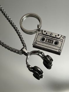 "The ultimate present for him: A sleek Stainless Steel Vintage Cassette Keychain. Headphone pendant option available.  Functional, Fashionable & Durable Men's Stainless Steel. Stainless Steel Vintage Cassette Keychain - Perfect Gift for the DJ, Musician, or Music Lover in your life. Amazing detail. Length 1.5\" Width 3/4\" Whether you are buying for yourself or the man/woman in your life, this is going to be the piece that you/he/she will love for years to come!  K E E P * I N * T O U CH https:/ Dj Gifts For Men, Gifts For Musicians Boyfriend, Cool Key Chains, Headphone Keychain, Grunge Gifts Ideas, Masc Jewelry, Music Related Gifts, Skateboard Jewelry, Things I Want To Buy