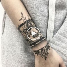 a woman's arm with a flower tattoo on it and a video camera in the middle