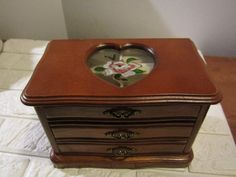 a heart shaped box sitting on top of a bed