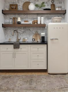 a white refrigerator freezer sitting inside of a kitchen