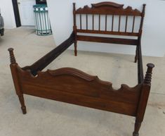 a wooden bed frame sitting on top of a floor