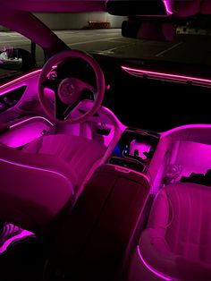 the interior of a car is lit up with purple light