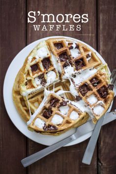 some waffles on a white plate with chocolate and marshmallows drizzled over them