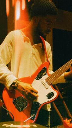 a man playing an electric guitar on stage