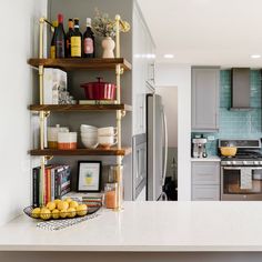 a kitchen filled with lots of counter top space and shelves next to an open refrigerator