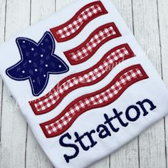 an american flag with the word straton embroidered on it, sitting on a wooden surface